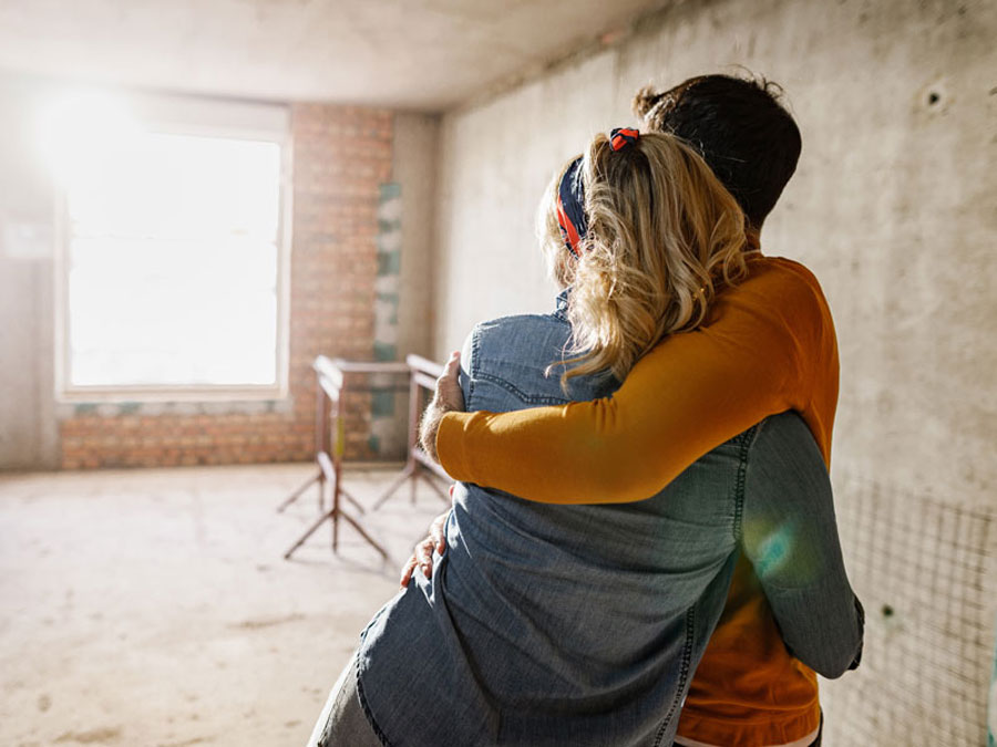 couple hugging before renovation